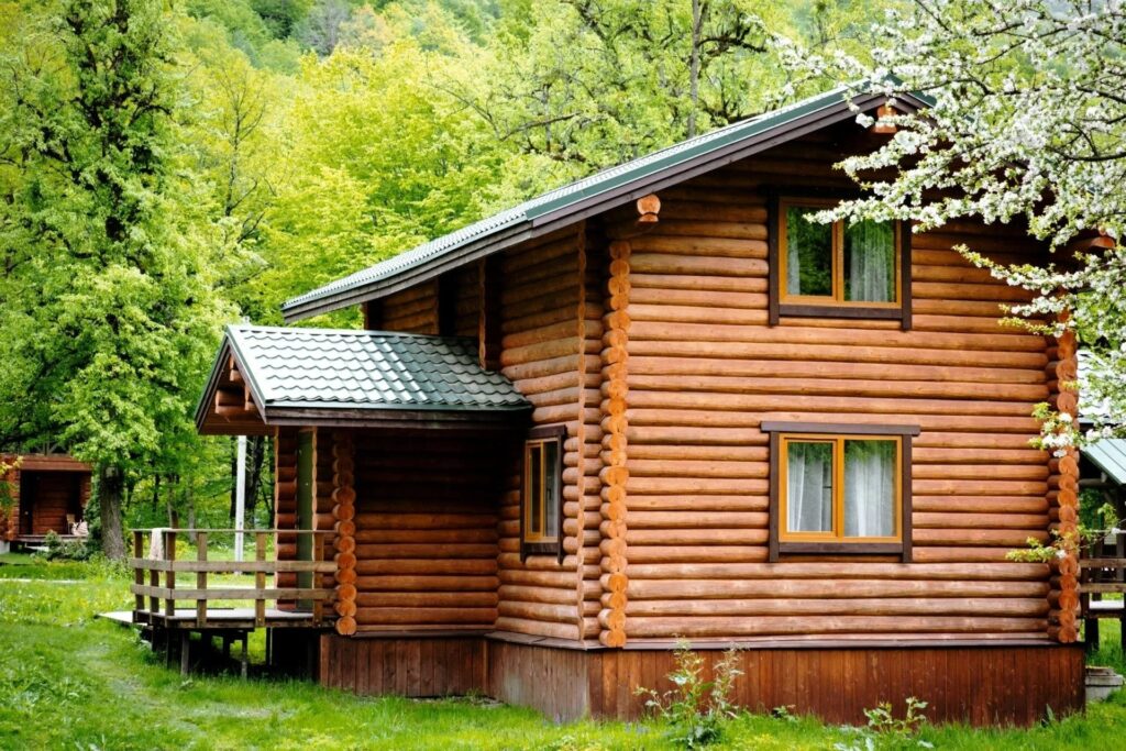 Bespoke wooden summer house surrounded by lush greenery, showcasing quality craftsmanship and design, ideal for outdoor living spaces.